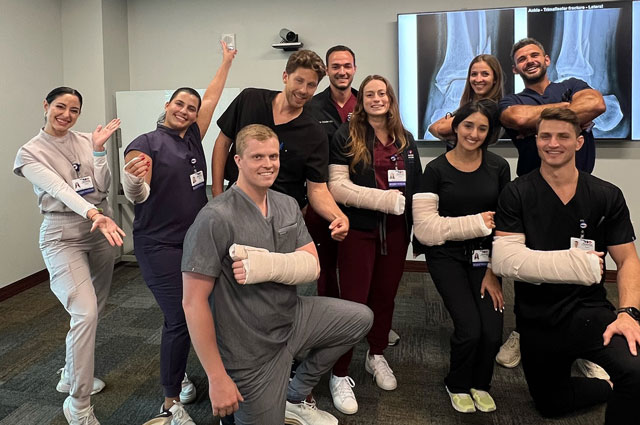 Emergency medicine residents practice casting a fracture